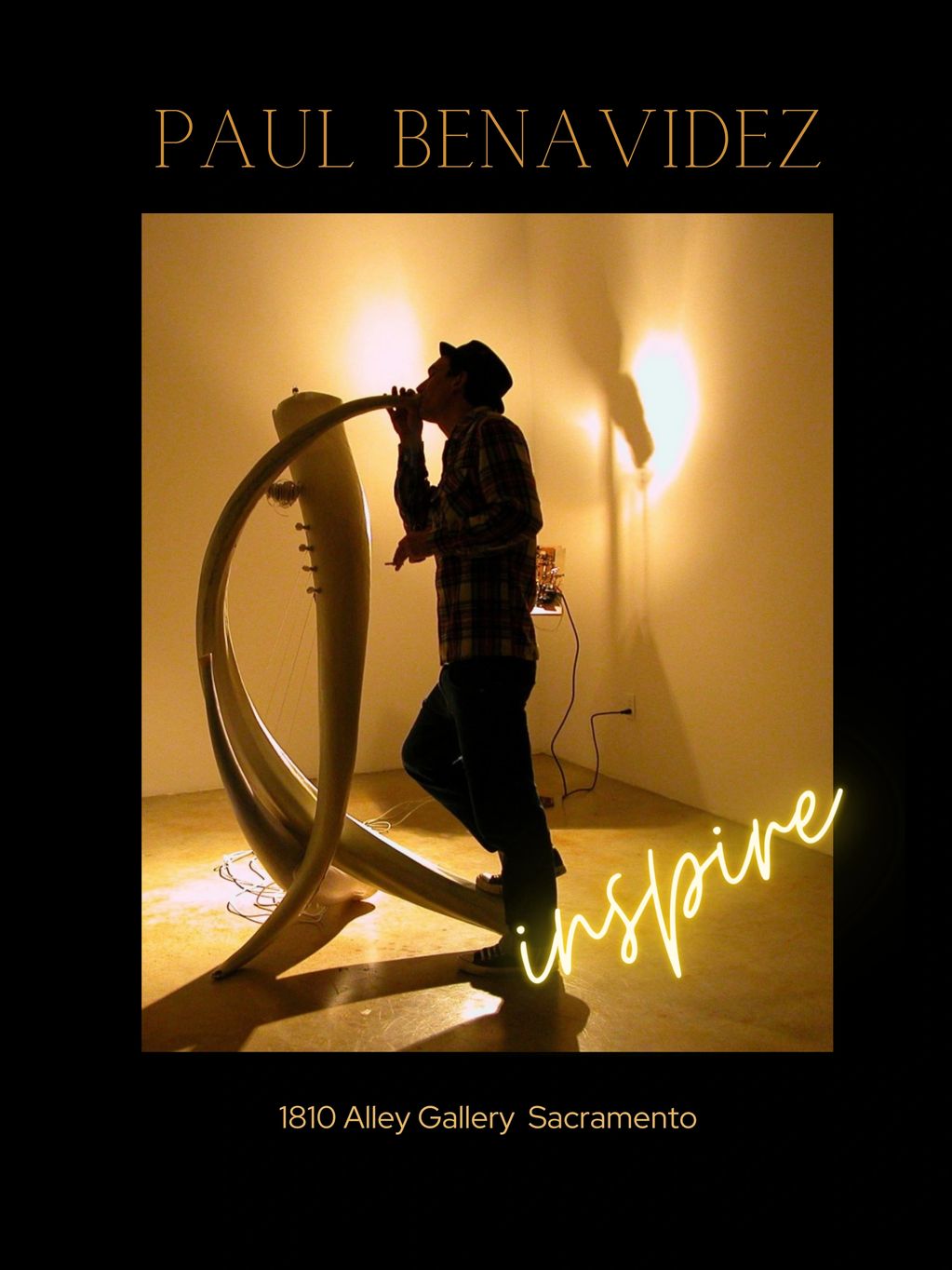 Artist Paul Benavidez playing a unique curved string instrument at 1810 Alley Gallery.