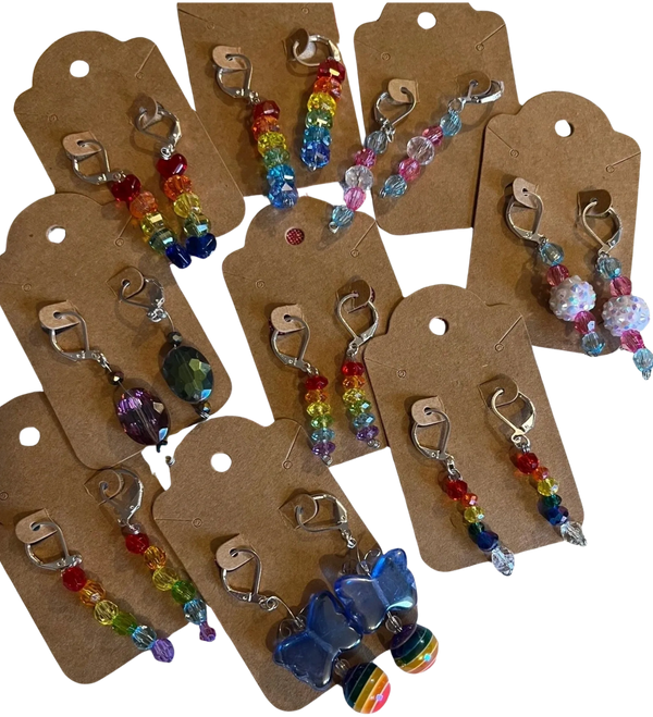 Colorful beaded earrings displayed on brown cards.