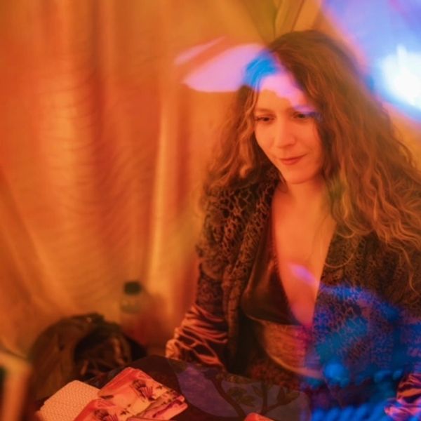 tarot reader reading tarot cards at table