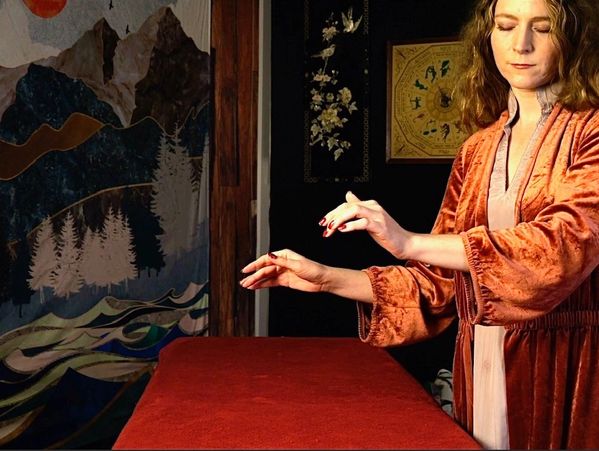 Reiki Master showing healing session technique to invisible person