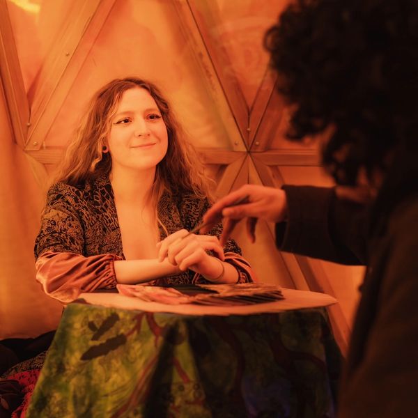 Tarot reader reading tarot and interacting with person