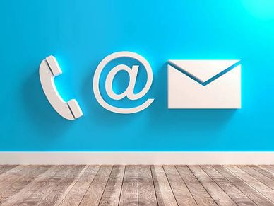 Icons of phone, email, and envelope on a blue wall with wooden floor.