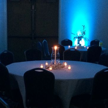Ballroom tables set with candlelight in a holiday theme