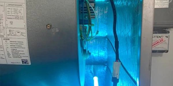 Blue UV light inside an HVAC system for air purification.