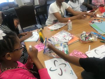 Children doing arts and crafts at a table.