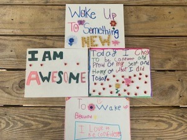 Motivational handwritten notes on wooden surface.