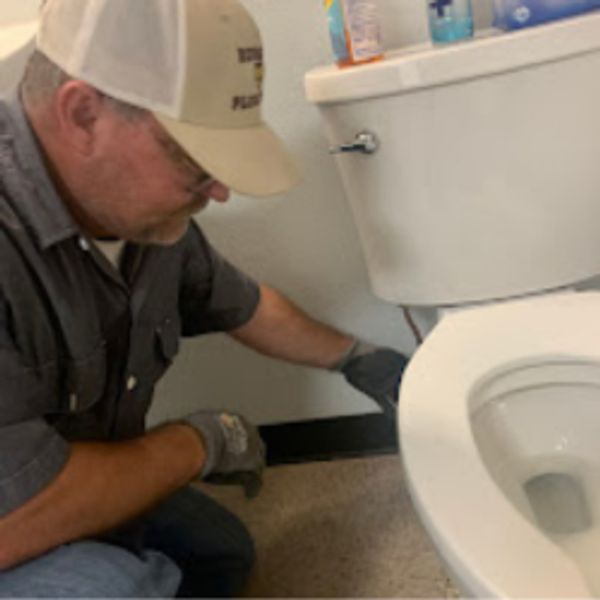 Russell repairing a toilet 