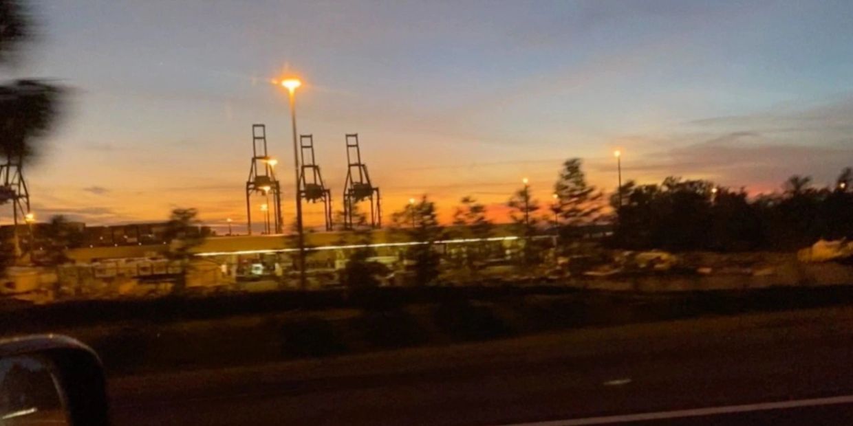 Highway view of Jacksonville Florida of three oil rigs