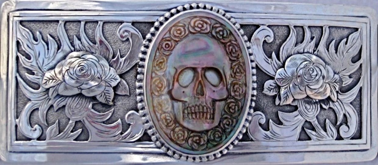 rectangle-shaped buckle with floral engravings and centerpiece on pearl of skull and flowers
