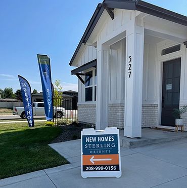 New model homes open at Sterling Heights with directional signs.