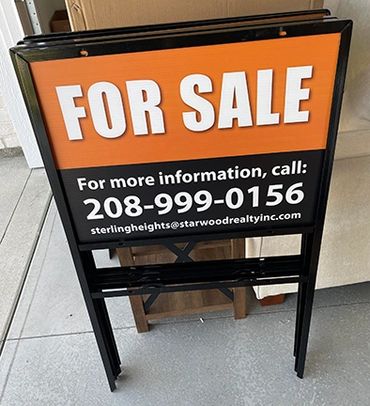 Real estate For Sale sign with contact details.