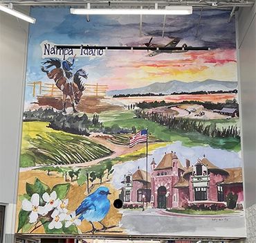 Colorful mural depicting Nampa, Idaho with nature and historic elements.