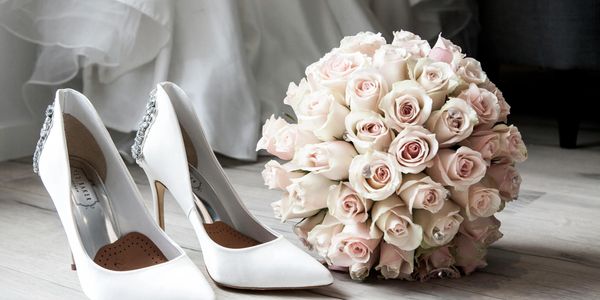 Wedding shoes and bouquet of roses 