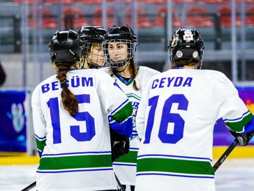 A team of women playing hockey