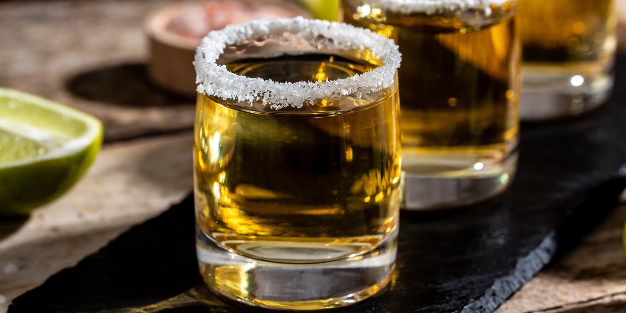 a glass of liquor with salt on the rim on a table