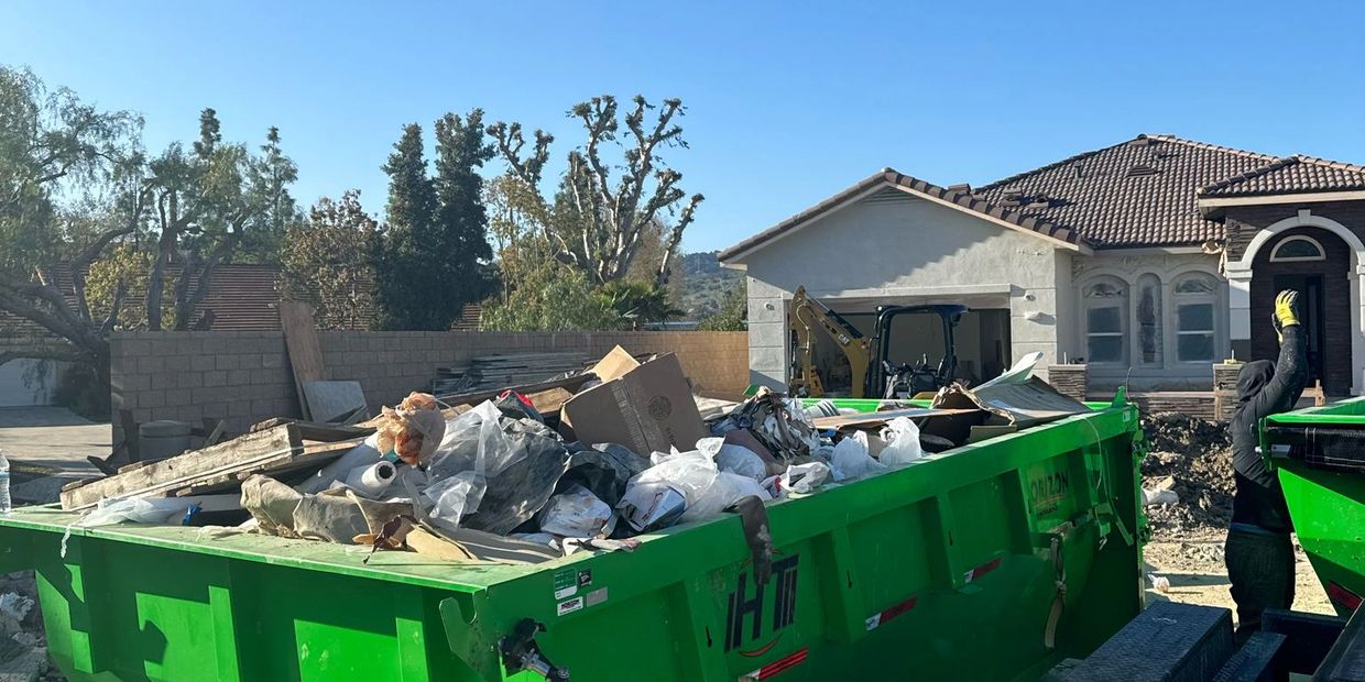 Construction debris removal services with bin rental on site.