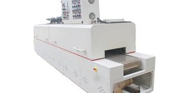 Large industrial conveyor oven with control panel and ventilation fans.