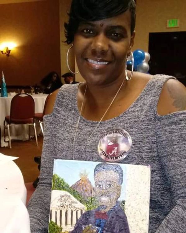 Keke Collins accepts portrait of her son, Donta Duane Collins.