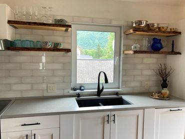 Floating Cottonwood shelving compliments this beautiful remodeled kitchen.  Penetrating epoxy  adher