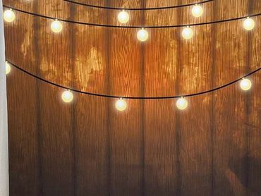 This Wooden Fence with Lights backdrop is great for a fun Photo Booth Experience. 