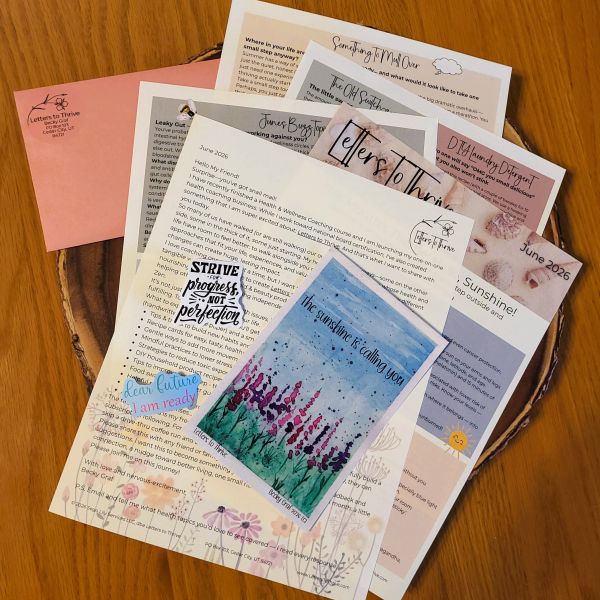 A collection of colorful, inspirational letters and notes spread on a wooden surface.