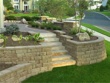 Engineered retaining wall and raised garden bed installation to level a property.