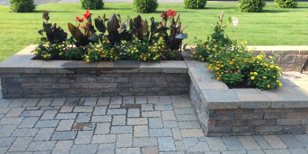 Paver patio, stacked paver block planter with coping, perennials and annuals planting