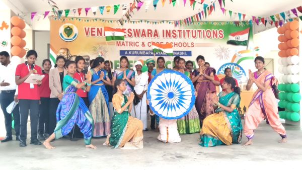 Students celebrating with Indian flags and traditional attire at a school event.