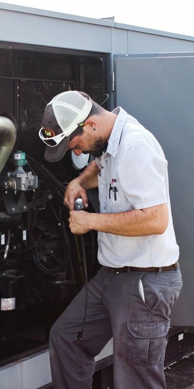 Outdoor technician installing generator.
