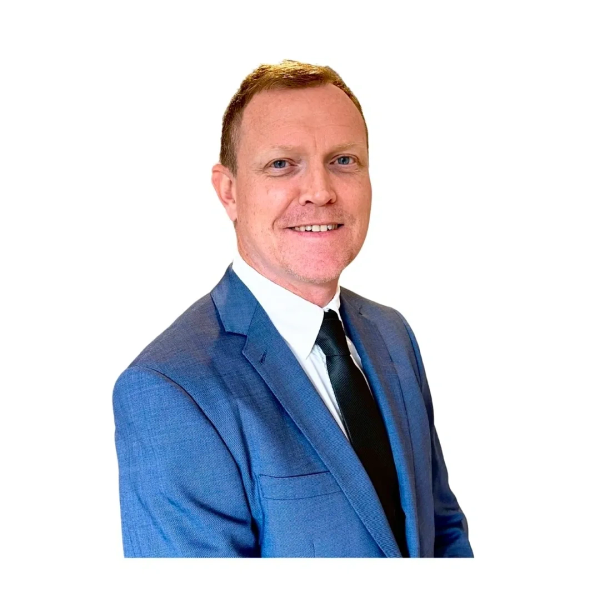 Man in blue suit smiling.