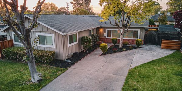 A charming single-story East Bay home at golden hour with tidy landscaping and a long driveway
