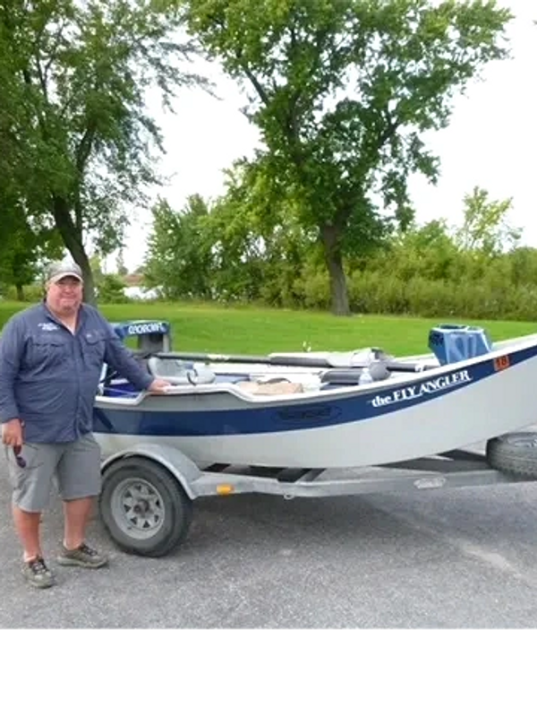 Scott stands with his drift boat