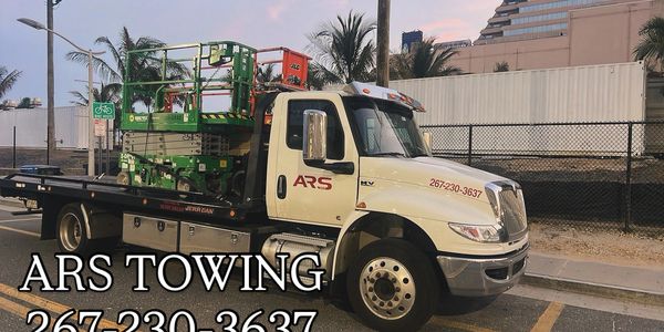 Equipment hauling service provided by ARS Towing