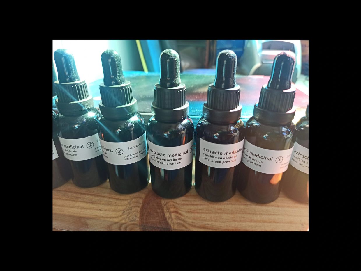 Bottles of medicinal cannabis extract in olive oil with droppers.