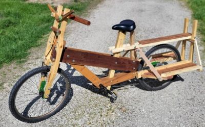 A unique cargo bike made mostly from wood with a sturdy frame and large rear platform.