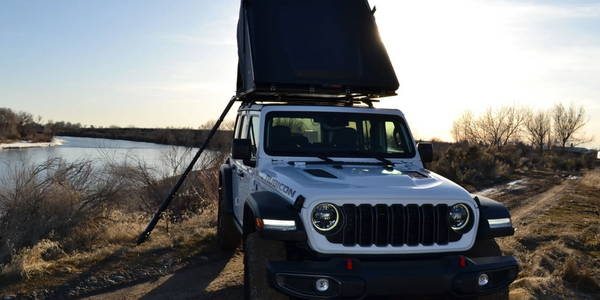 This is a Caldera Adventures Jeep with a roof top tent all set up and ready for sleep.