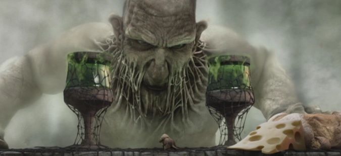 A giant menacing creature looming over a table with two glasses and cheese.