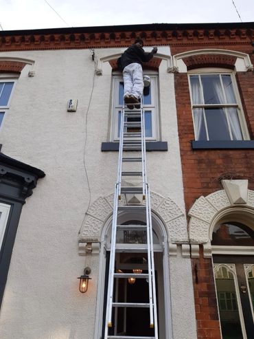Exterior walls and window being painted and decorated