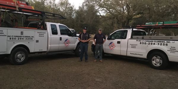 team photo with the company trucks