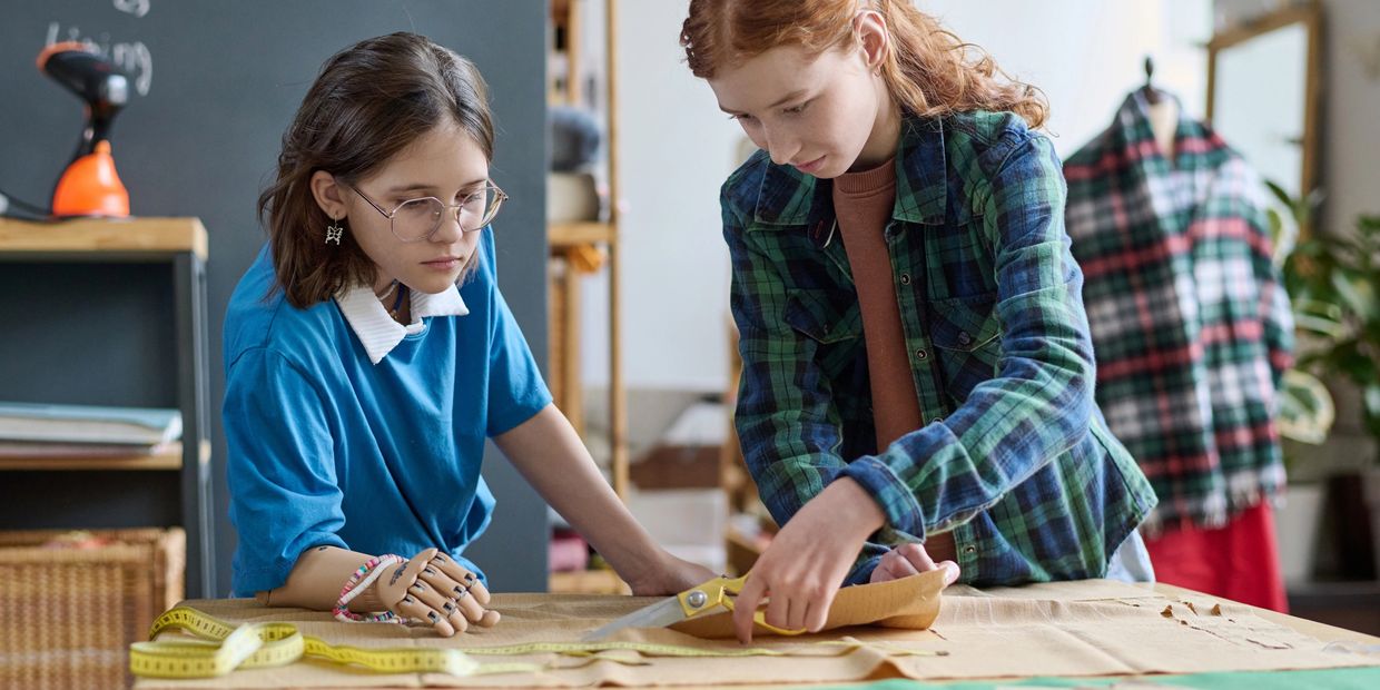 Kids learning patternmaking at UMAI Foundation — turning shapes into garments with focus and creativ
