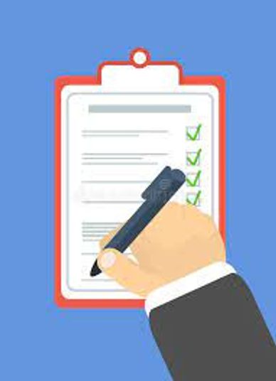 Hand holding pen checking off items on a checklist.