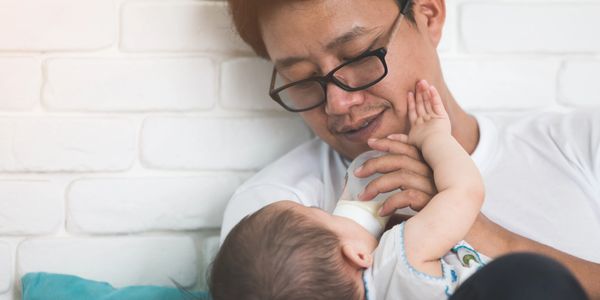 Dad feeding infant