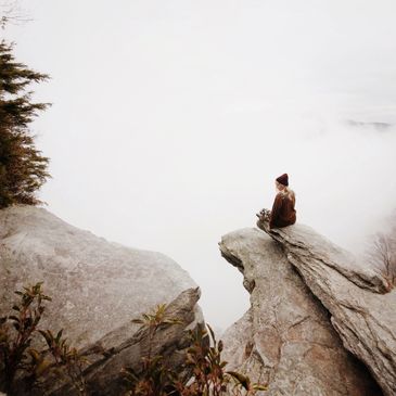 Peaceful woman on rock cliff