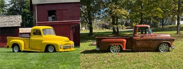 Two vintage pickup trucks, one yellow and restored, the other rusty and weathered, parked on grass.