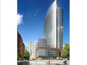 Modern glass skyscraper in an urban setting.