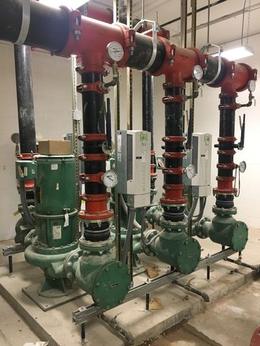 Industrial pumps and pipes setup in a mechanical room.