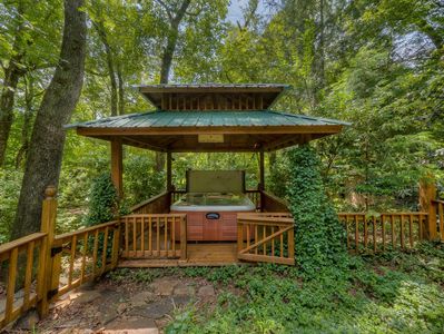 Relax in your own private hot tub in a gazebo. You won't want to go back to reality. 
