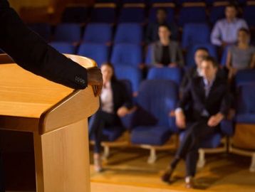 An African-American speaker at a mental health speaking engagement. 