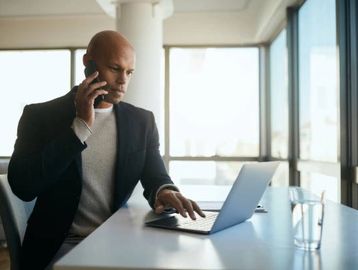 An African-American therapist speaking with his client. 
