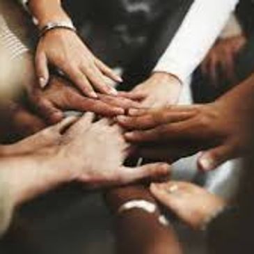 many people with their hands on each other's hands